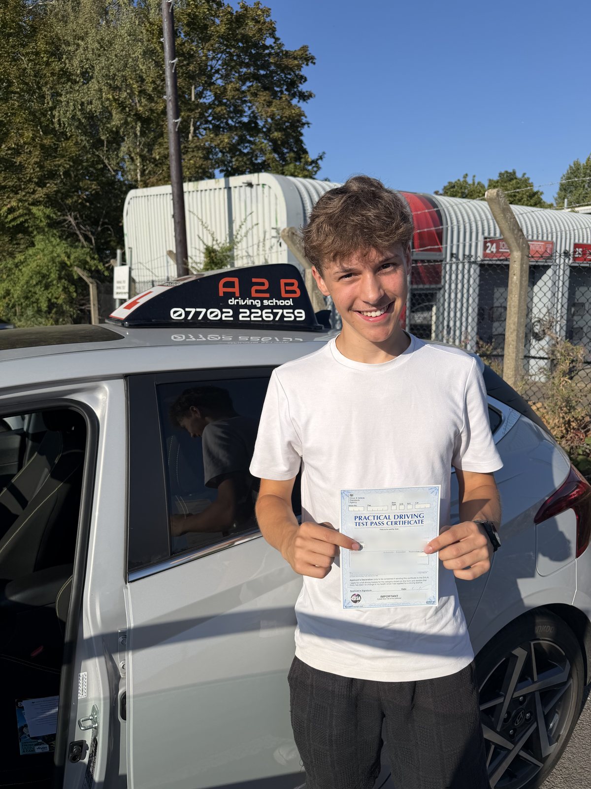 A2B student holding their driving test pass certificate